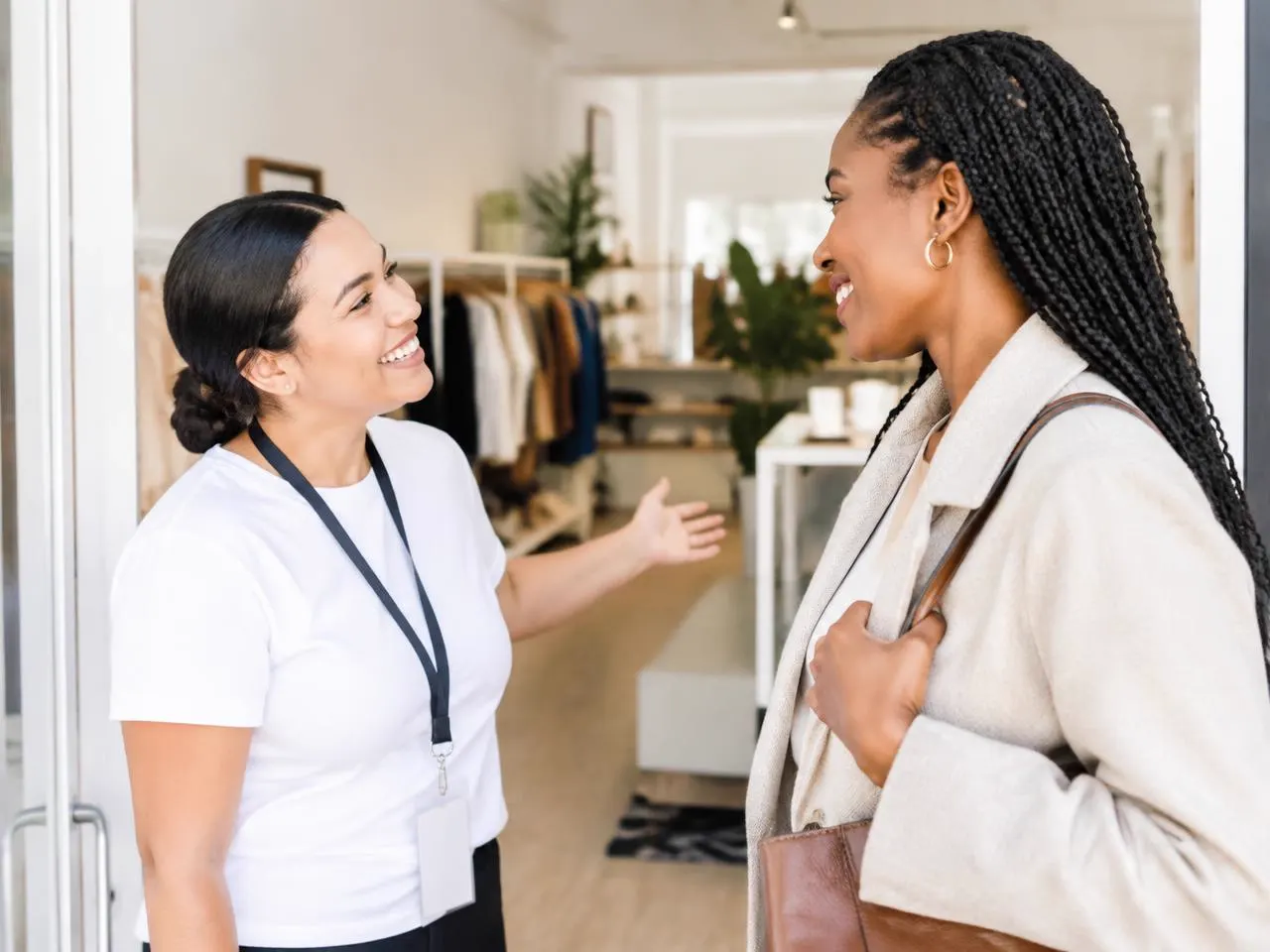 Volunteer warmly greeting a guest at the boutique entrance